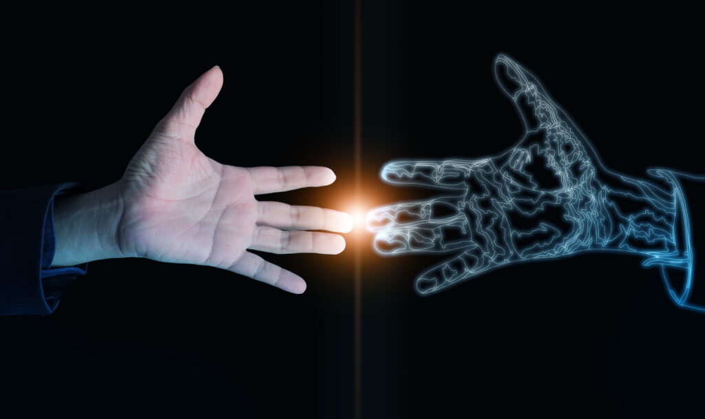 真人手指與數位 AI 手指即將接觸，象徵人工智慧逐漸融入生活，也提醒人們在科技時代保留判斷力與信任。